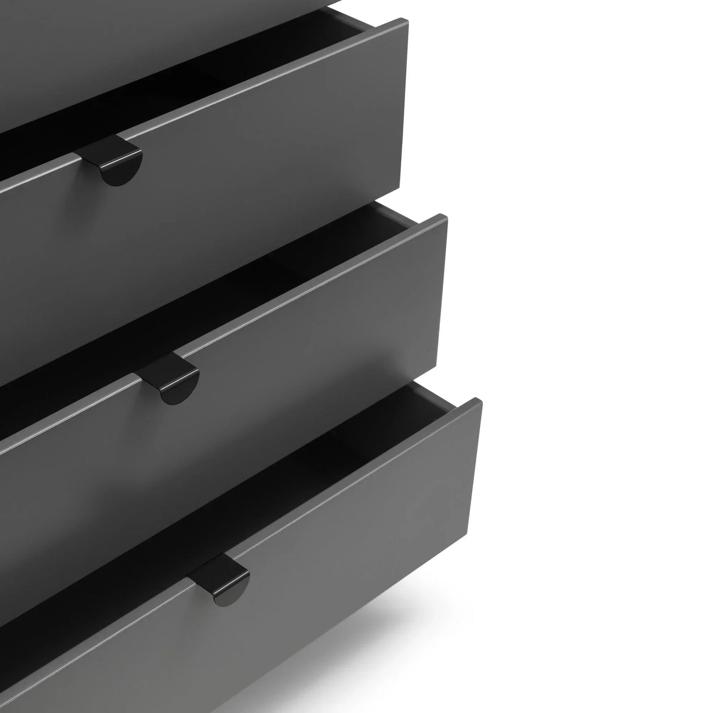 Closeup of grey chest of drawers with three open drawers and modern handles