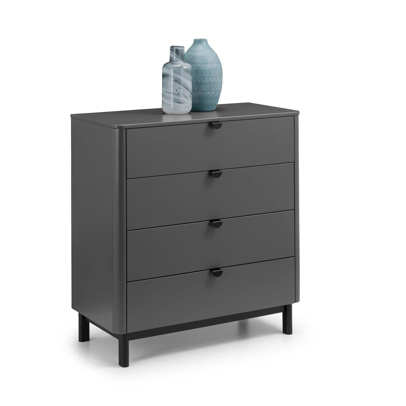 Grey chest of drawers with four drawers, black handles, vases on top, angled view
