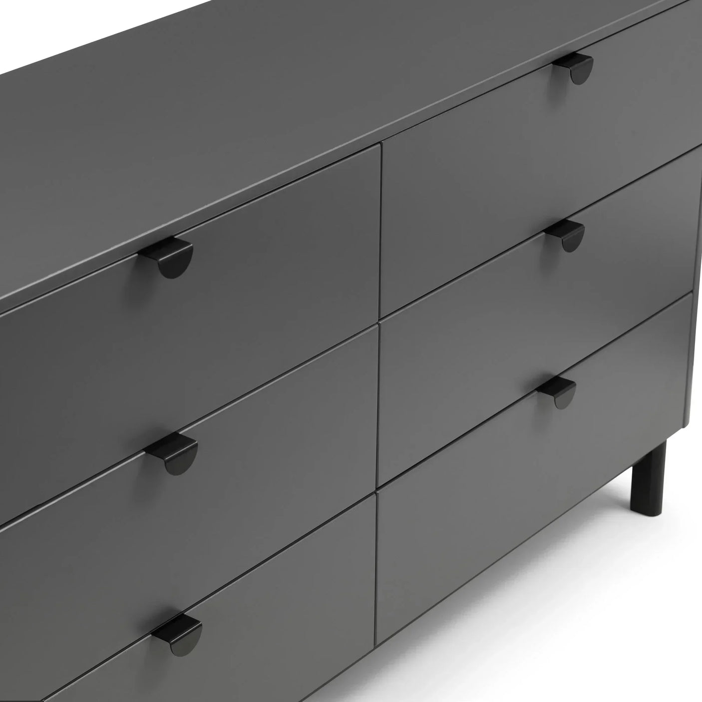 Charcoal grey chest of drawers with six drawers and black handles, close-up side view
