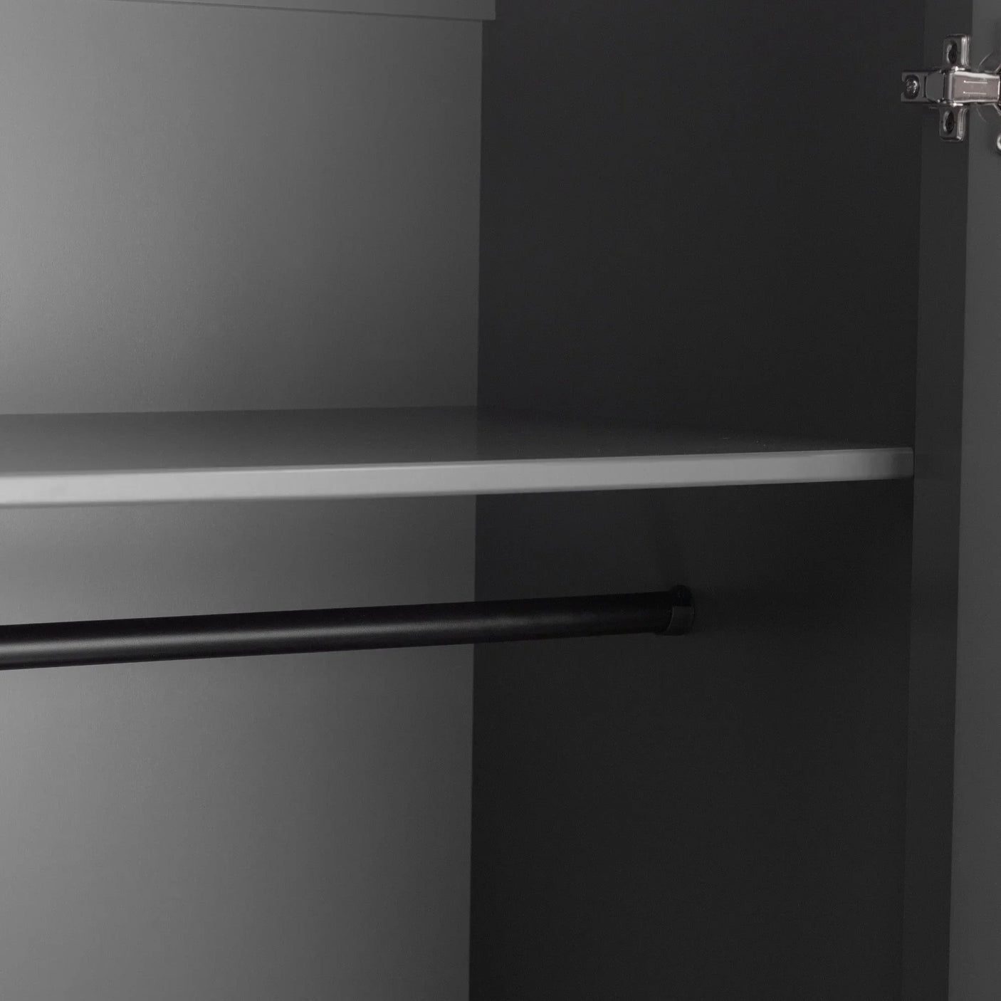 Grey wardrobe interior with shelf and black hanging rail