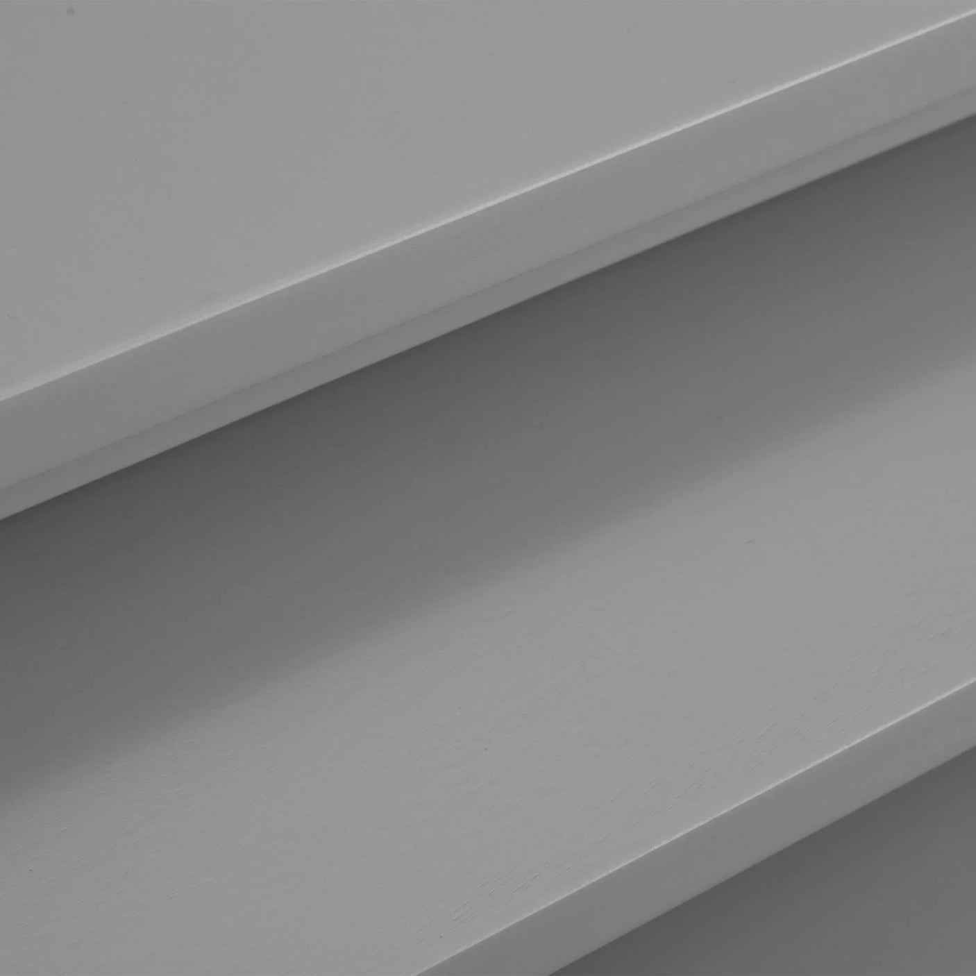 Close-up of grey nest of tables showing smooth painted tabletop surfaces