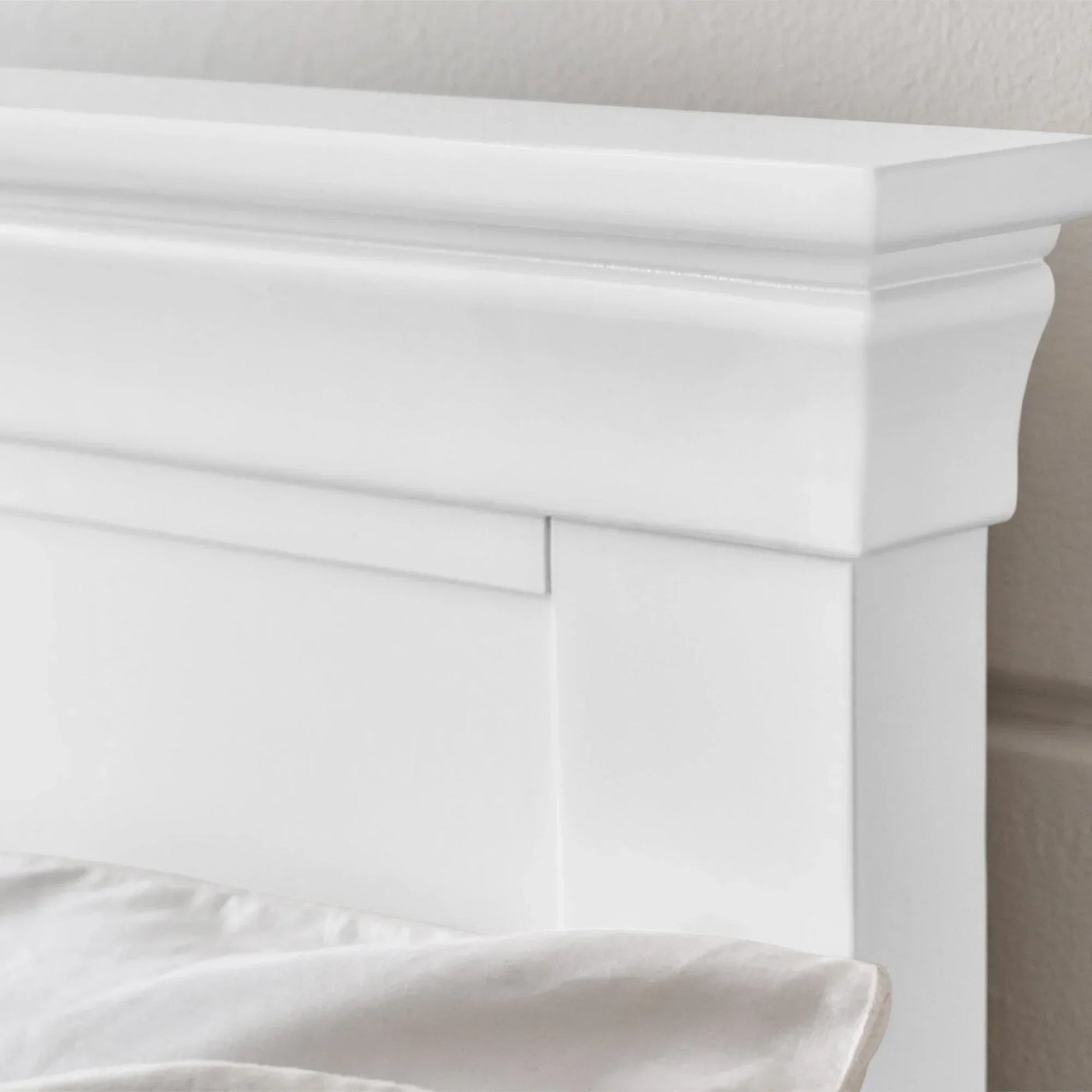 White king bed headboard close-up showing smooth painted wood finish and clean panel design