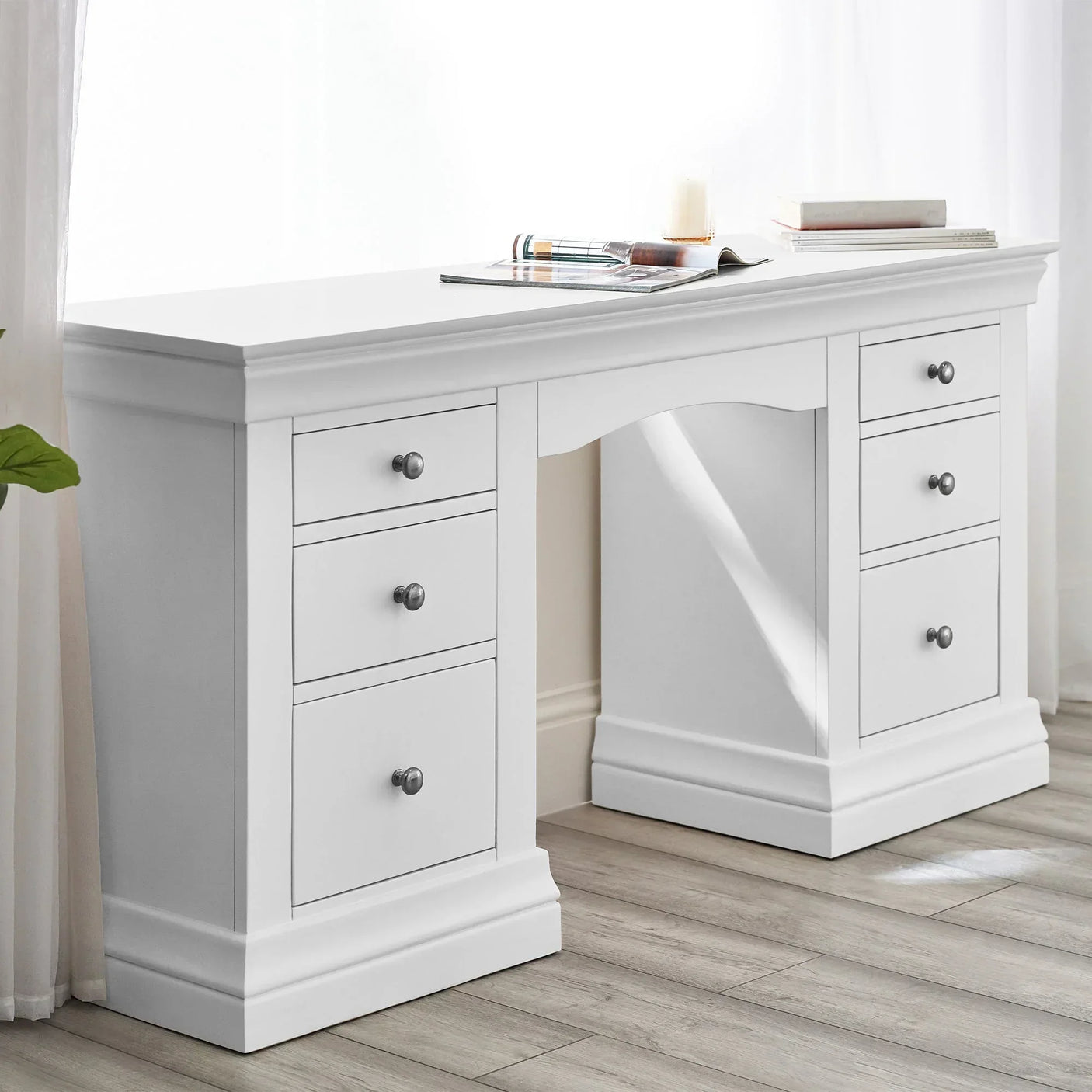 white dressing table with six drawers and decorative trim in bright room
