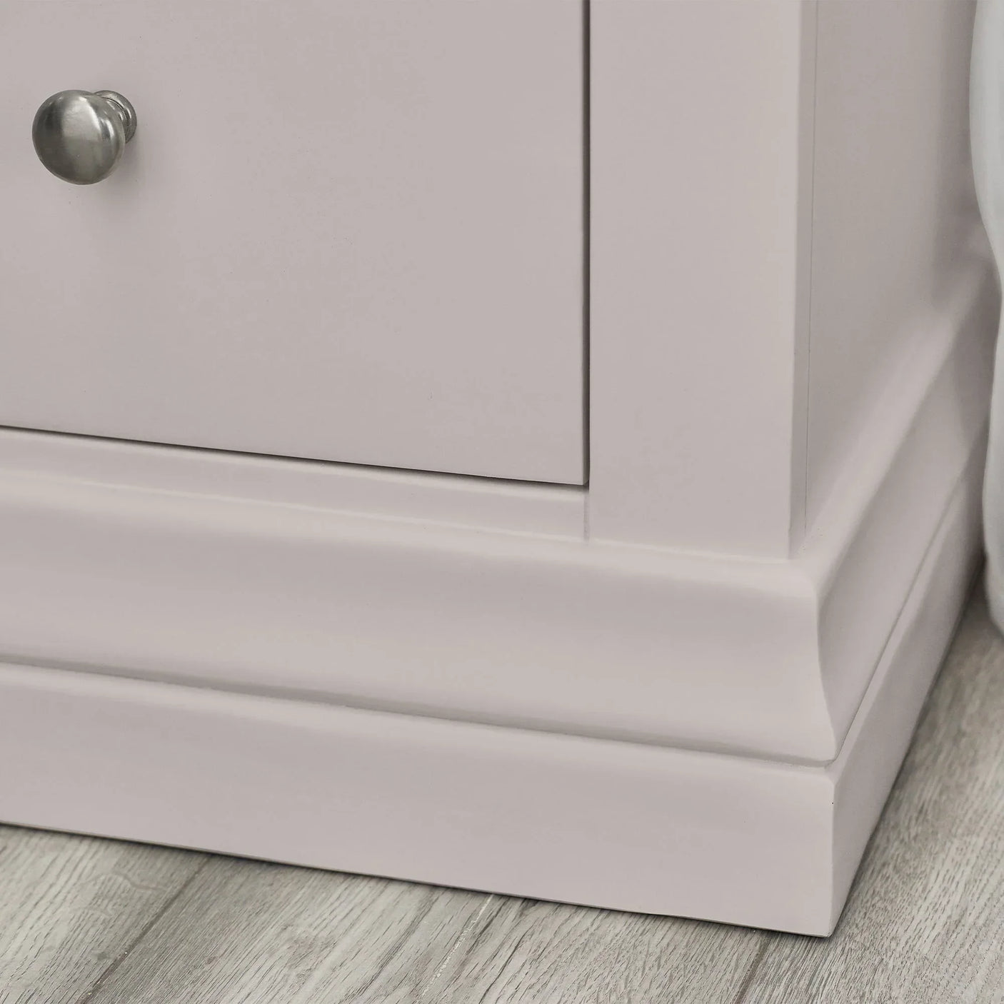 Grey dressing table base with brushed metal handle on wood floor