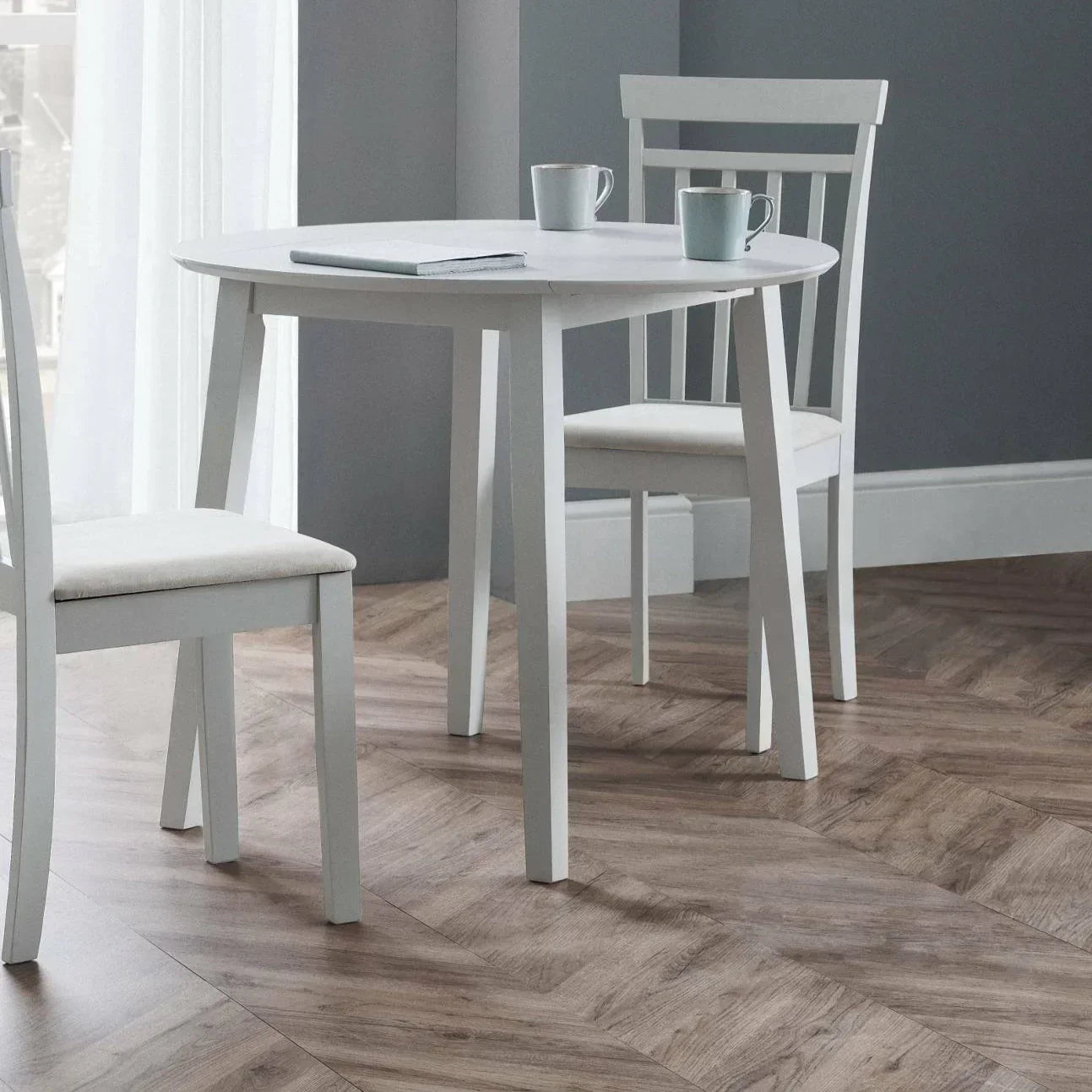 Coast grey dropleaf dining table with two matching chairs in a bright room