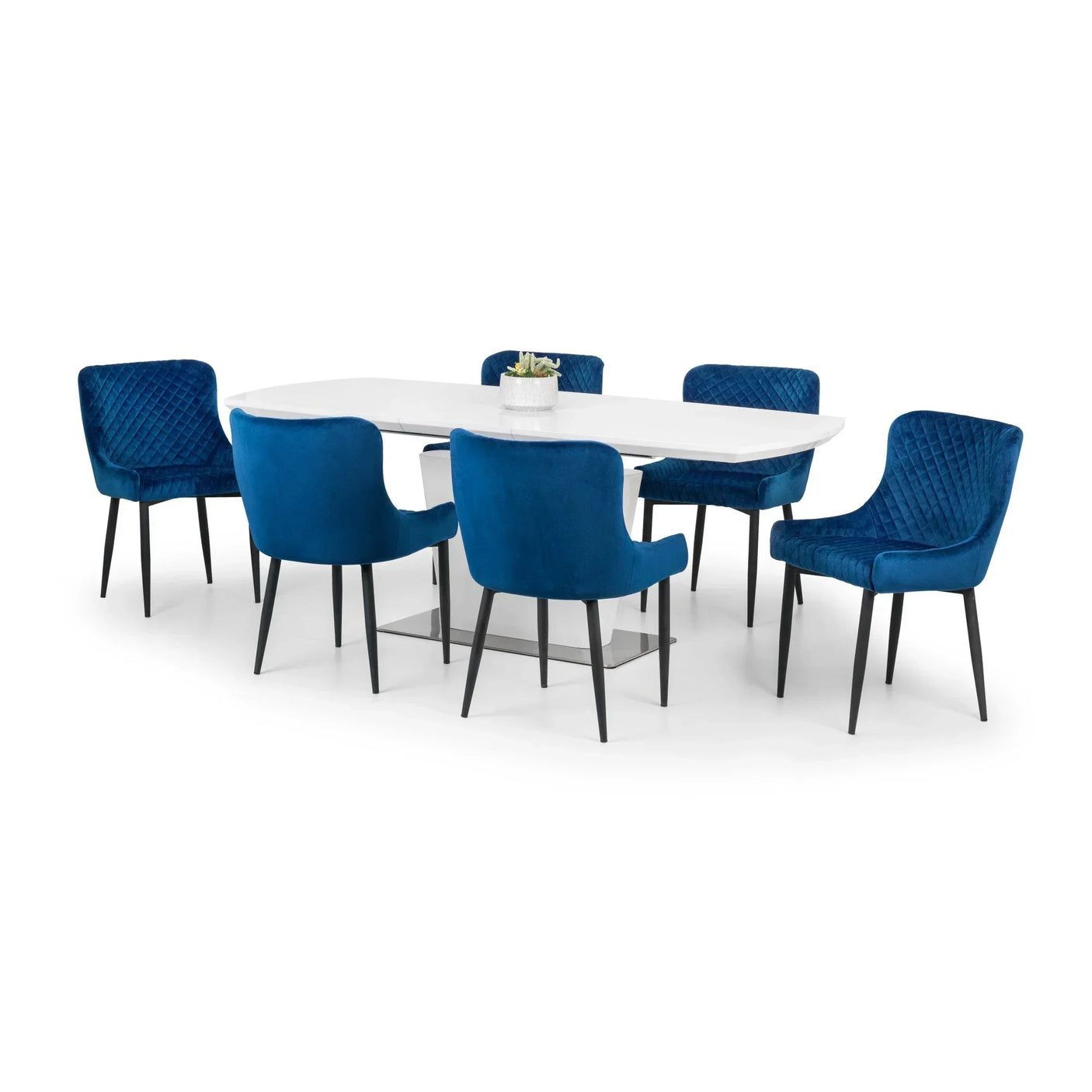 White oval dining table with six blue velvet chairs and black metal legs