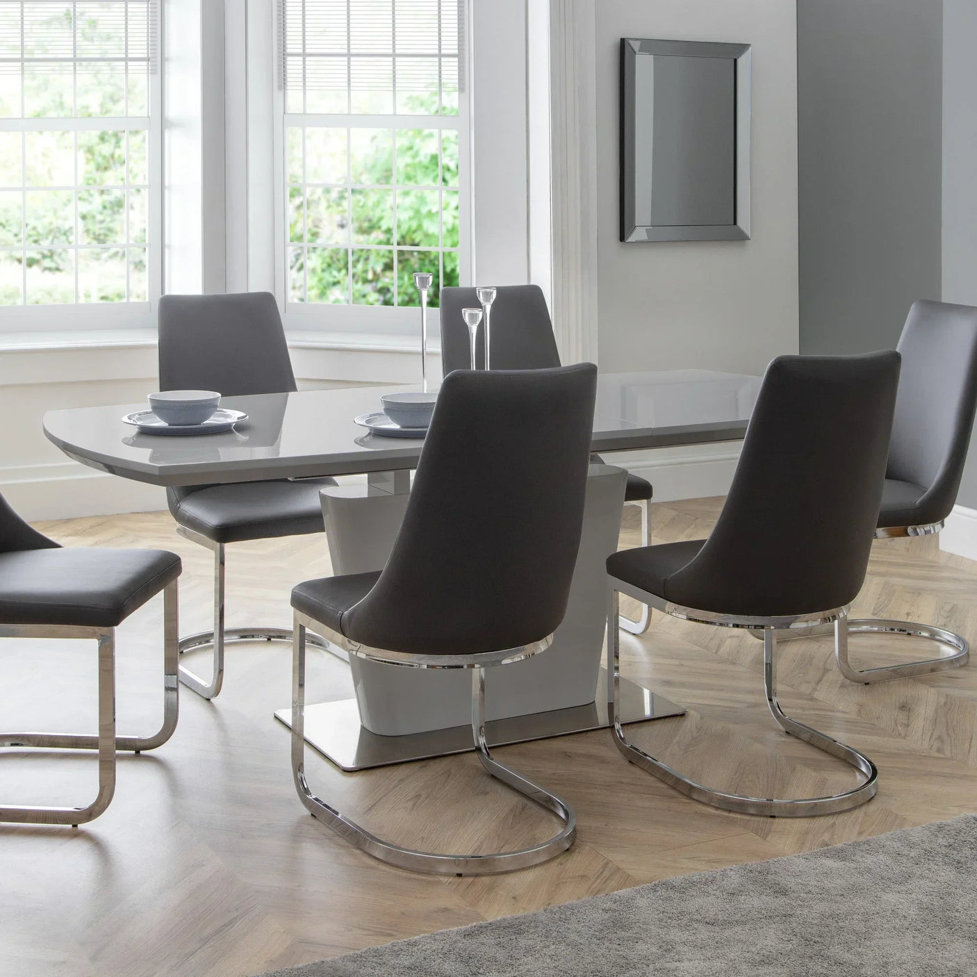 Grey dining table set with chrome cantilever chairs in modern dining room