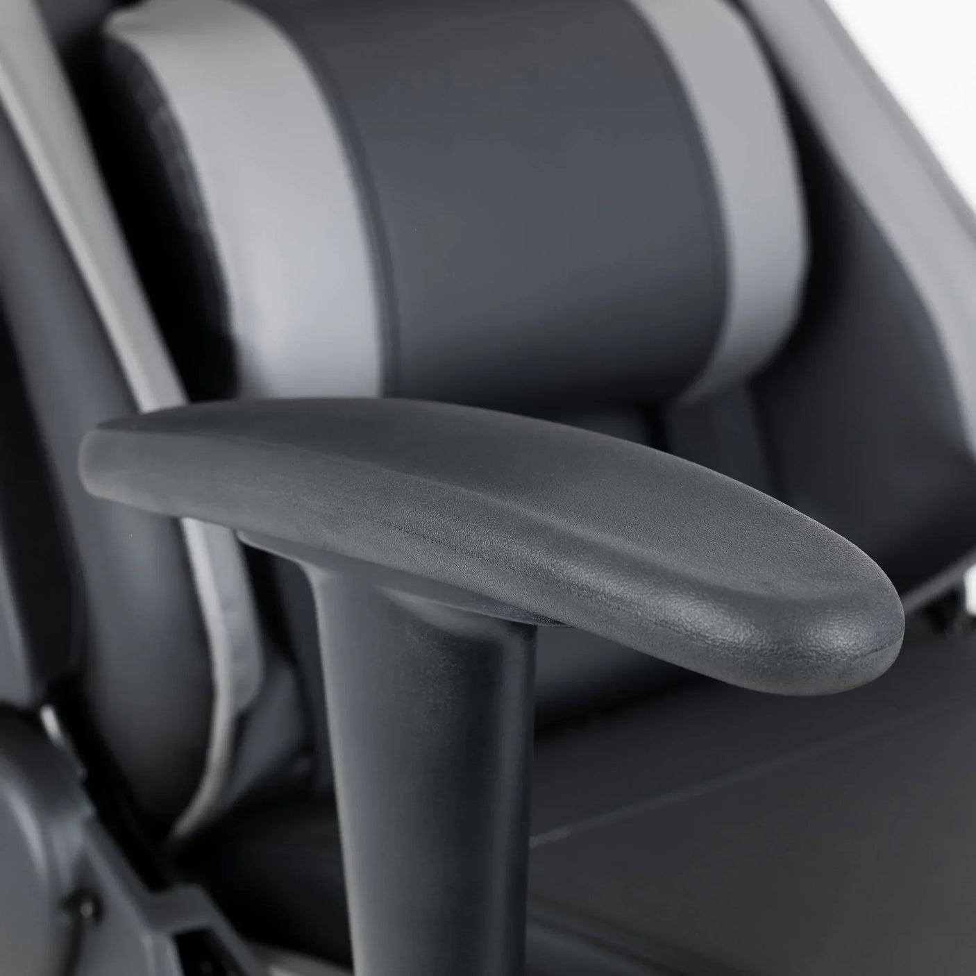 Comet gaming chair black adjustable armrest closeup with grey and black padded seat