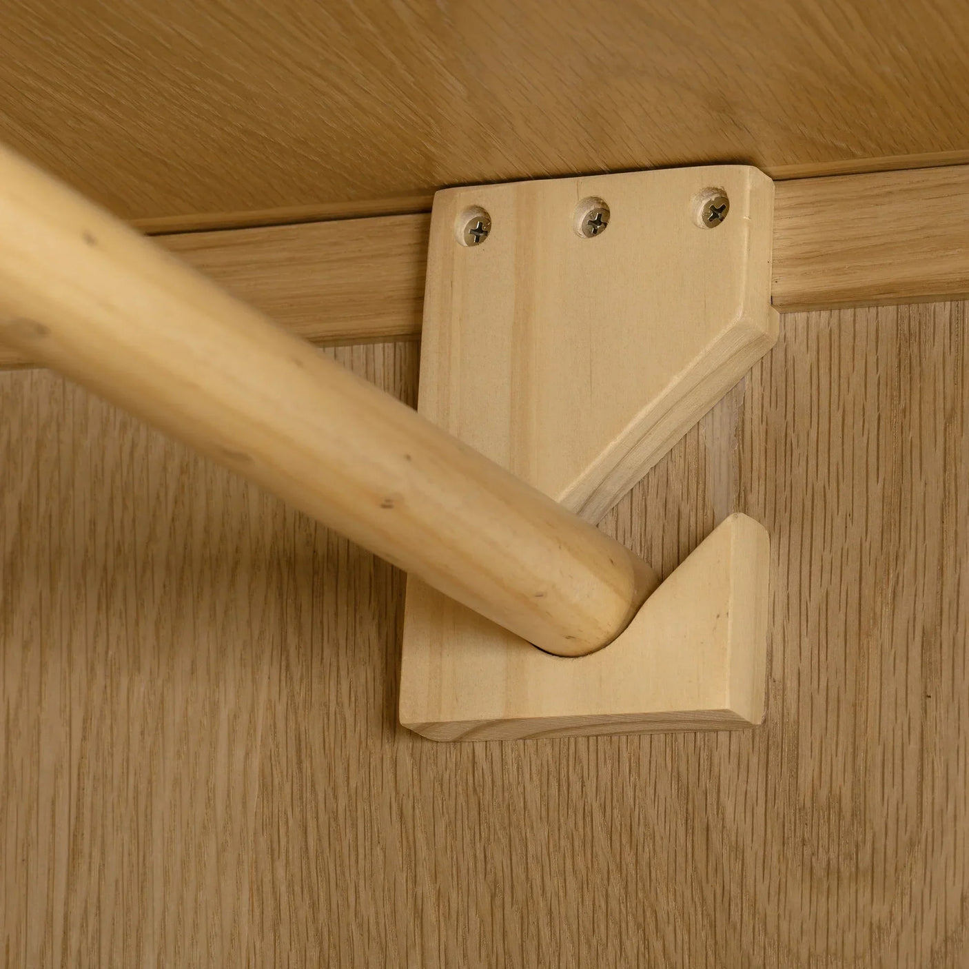 Oak wardrobe interior showing hanging rail and wooden bracket detail