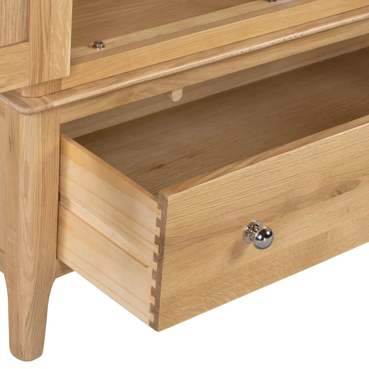 Cotswold oak wardrobe lower drawer with silver handle, close-up of wood joinery detail