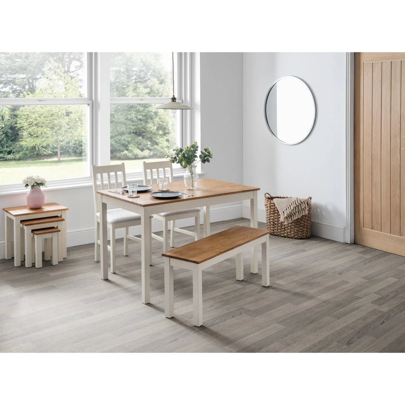 Rectangular ivory oak dining table set with bench and chairs in bright dining room