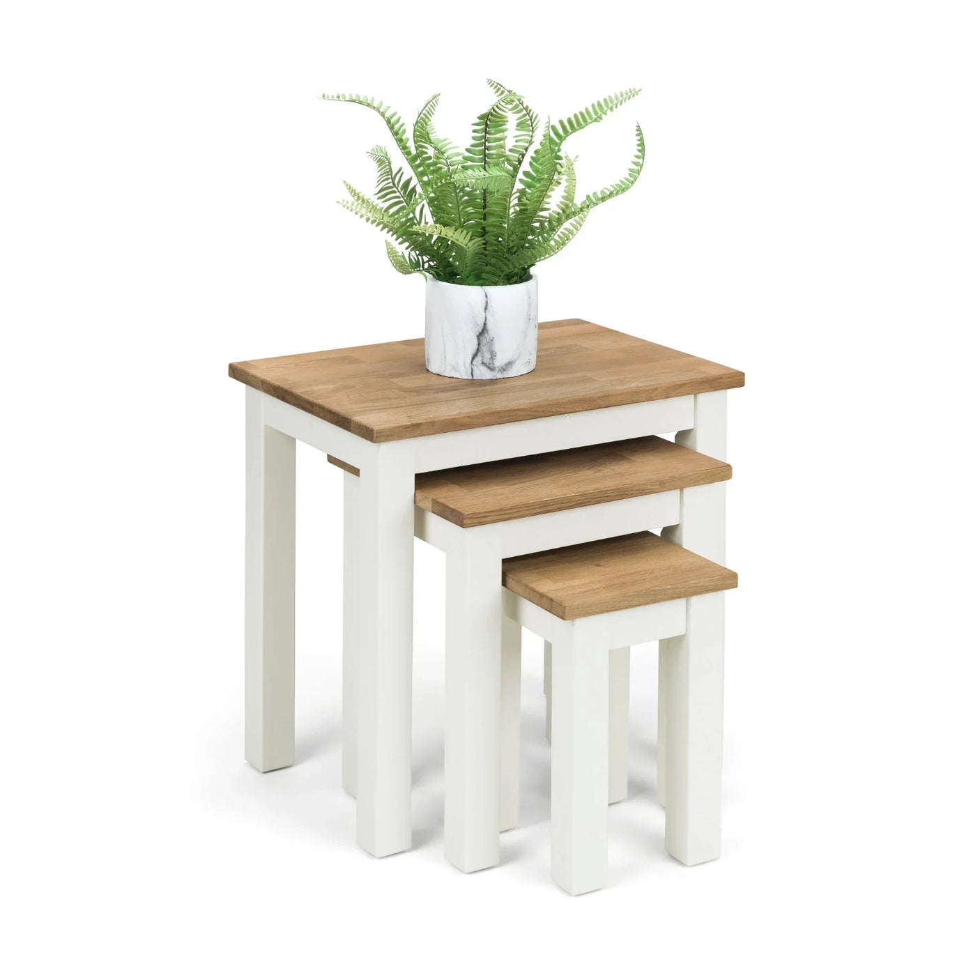 White and oak nest of tables with three stacked tables and a plant on top