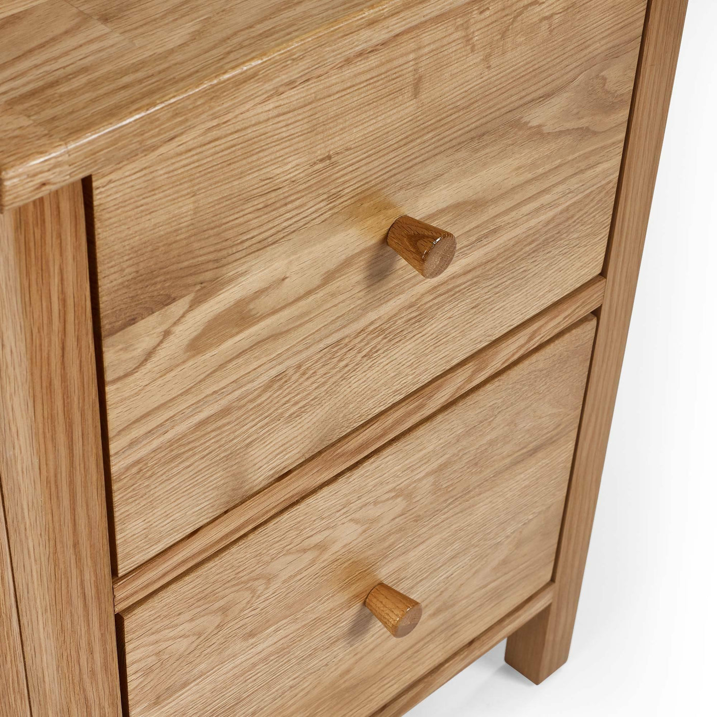 oak chest of drawers with two wooden handles and natural wood grain finish