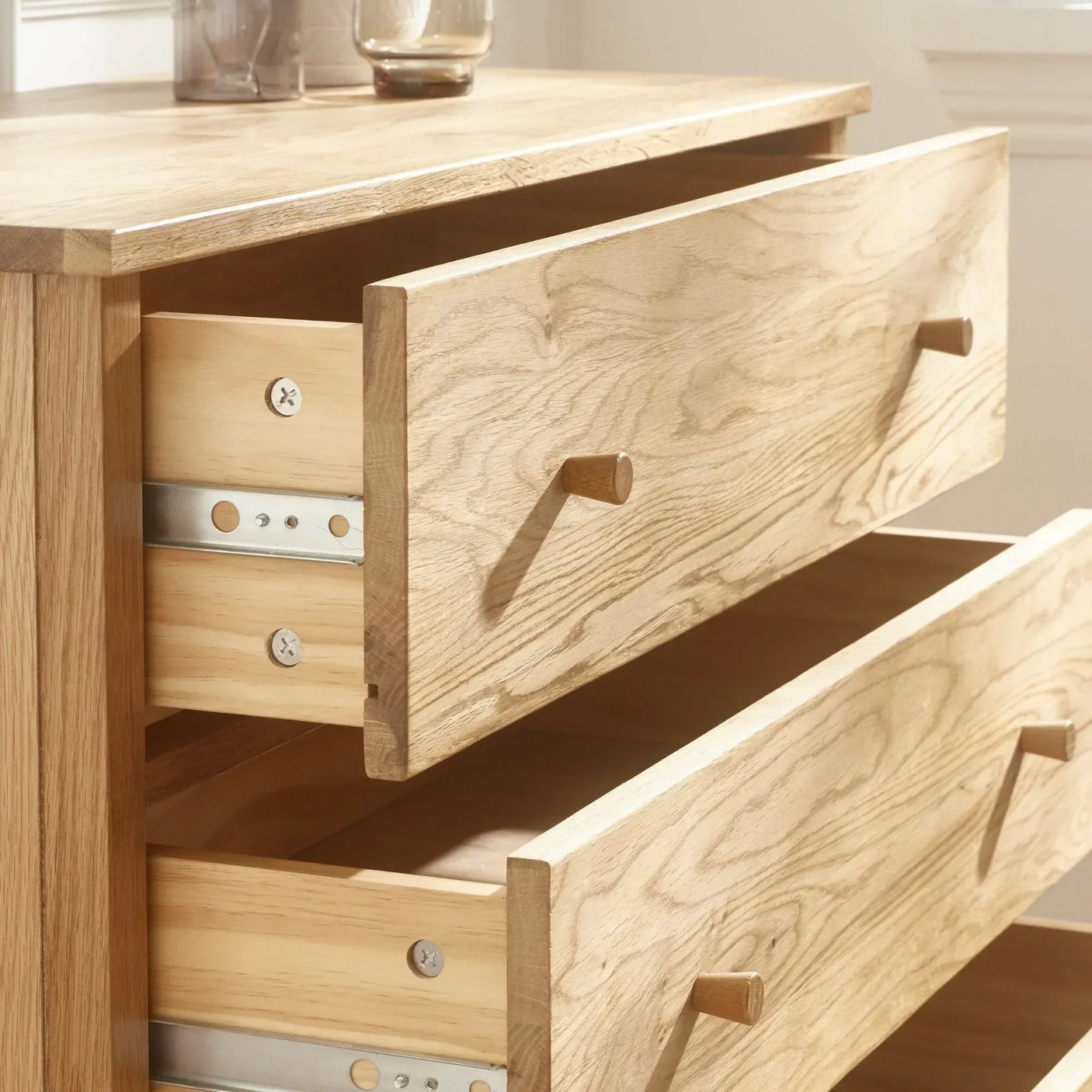Oak chest of drawers with metal runners, natural wood grain, two drawers open