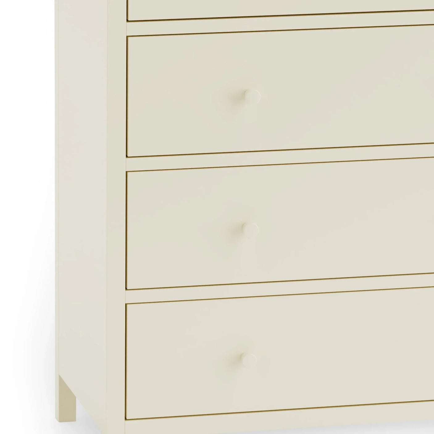 Cream chest of drawers with round knobs and smooth drawer fronts, close-up view