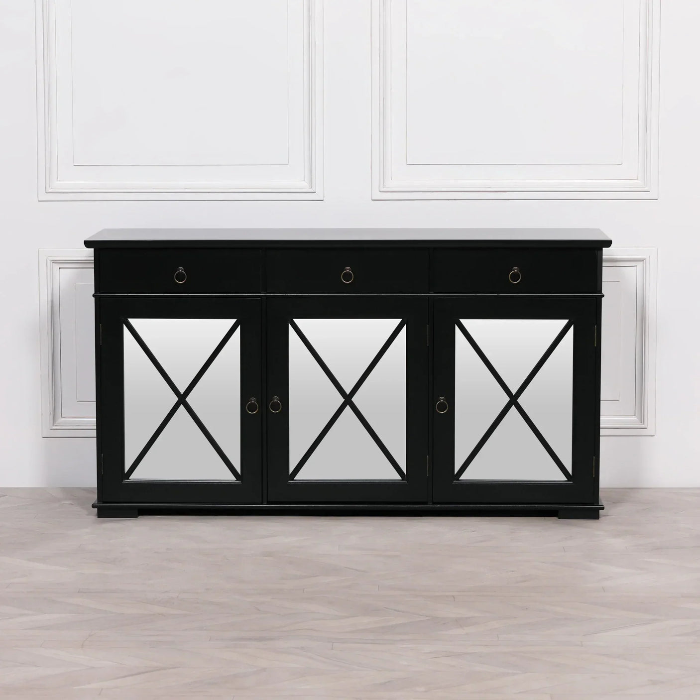 Black sideboard with mirrored doors and ring handles against white panel wall