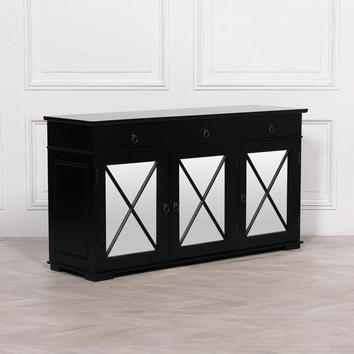 Black mirrored sideboard with three drawers and criss-cross door panels on wood floor