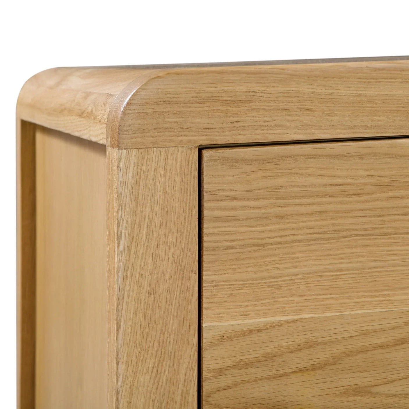 Oak bedside table closeup showing curved corner and wood grain drawer detail