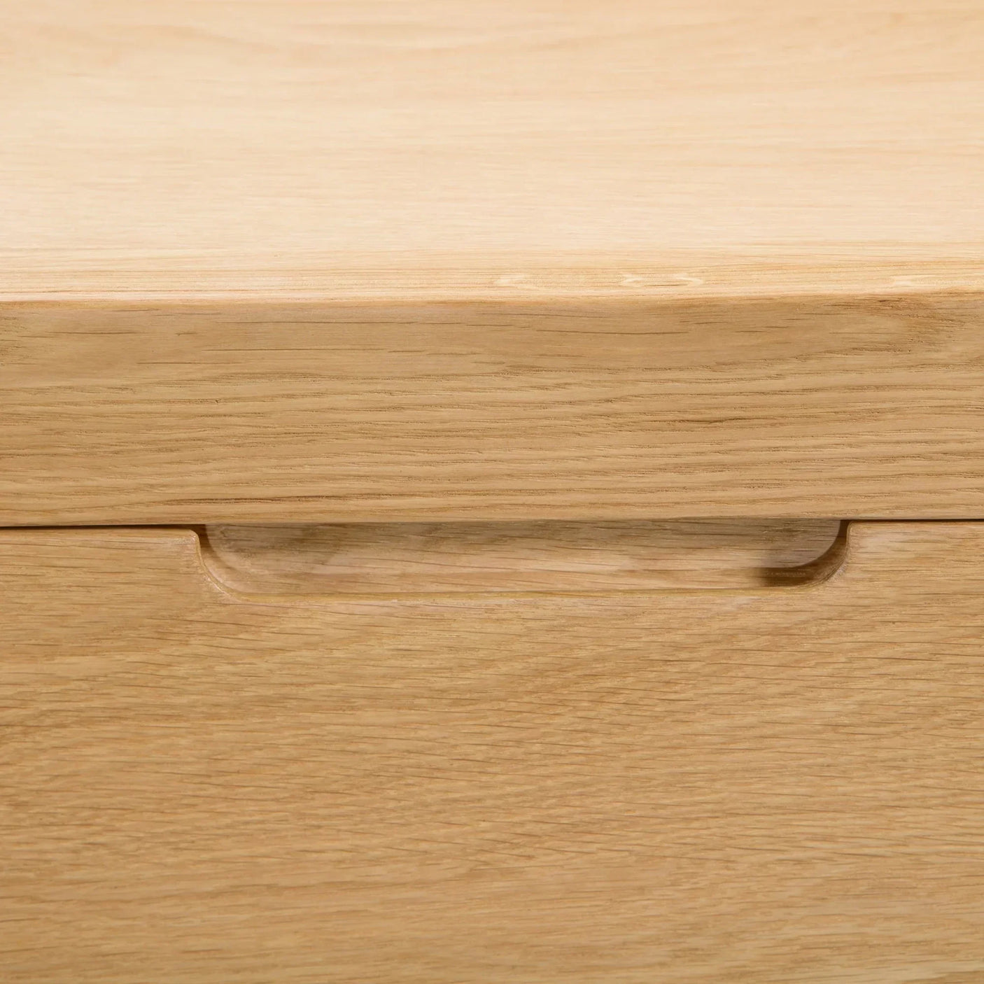 Detail of curved oak drawer handle on 3 drawer chest