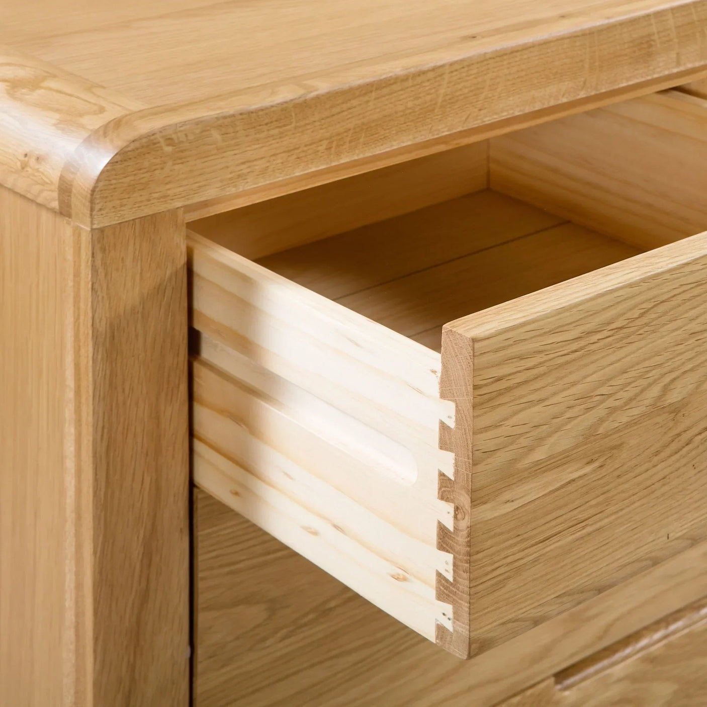 Oak 2 drawer chest close-up showing dovetail joint and smooth wood grain finish