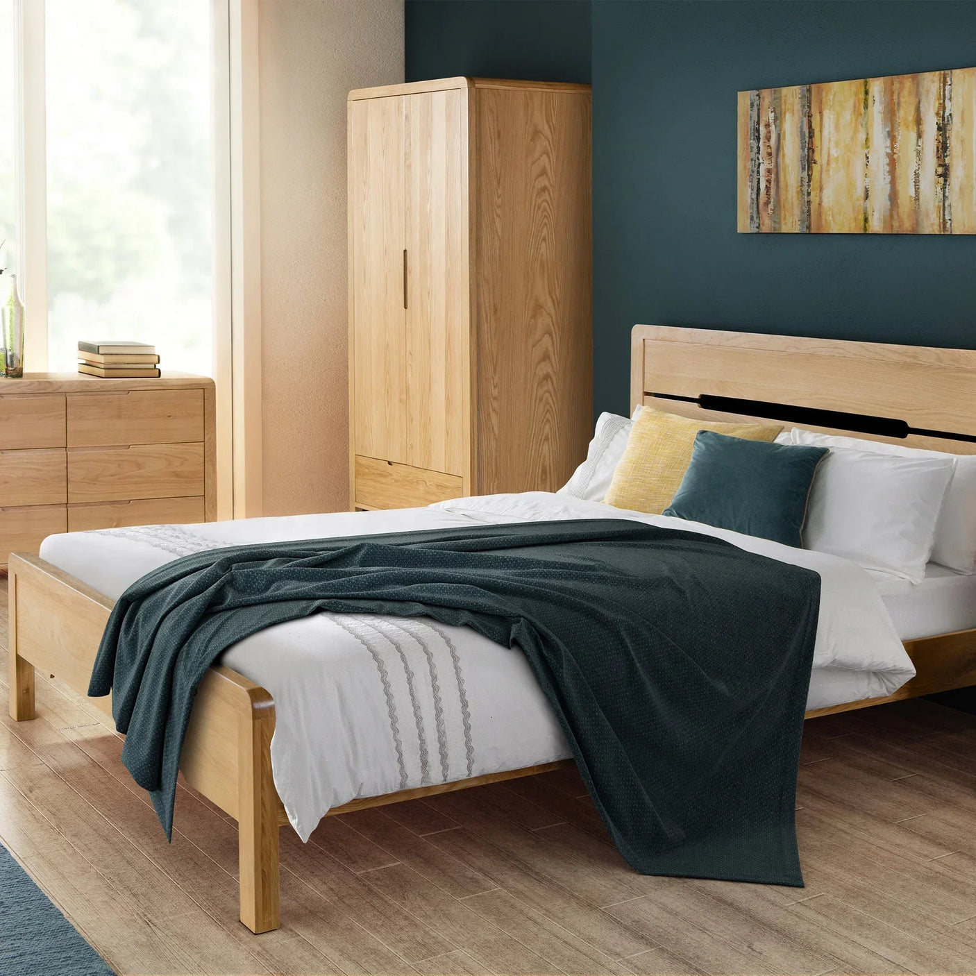 Oak wardrobe with two doors and one drawer in modern bedroom setting next to bed and dresser
