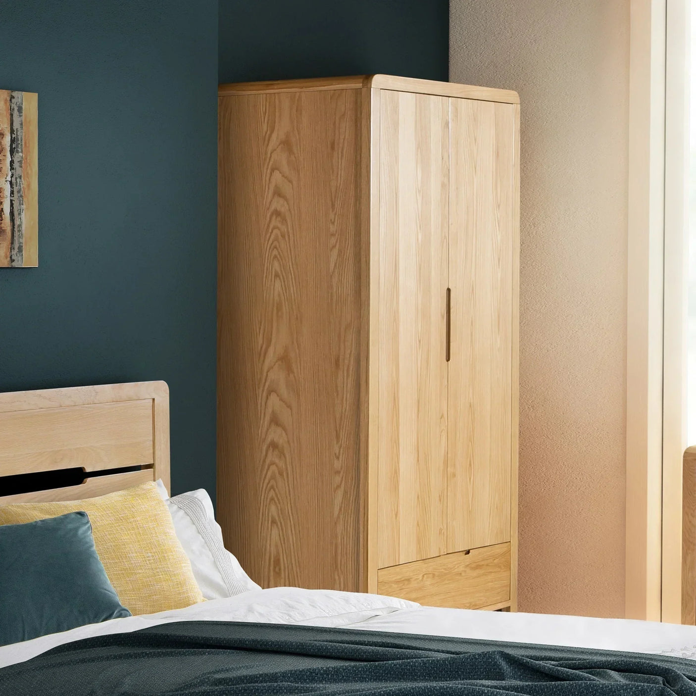 Oak 2 door 1 drawer wardrobe in modern bedroom with bed and pillows visible