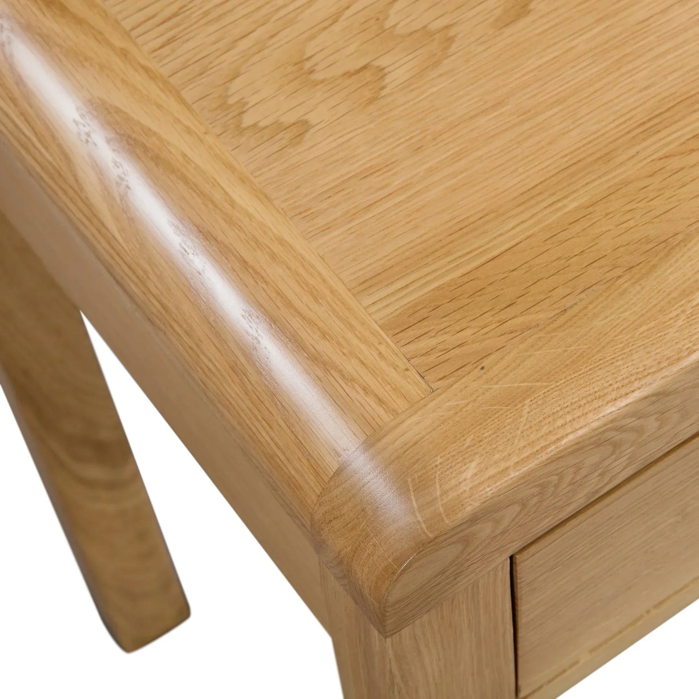 Close-up of oak dressing table corner showing drawer and curved wood edge