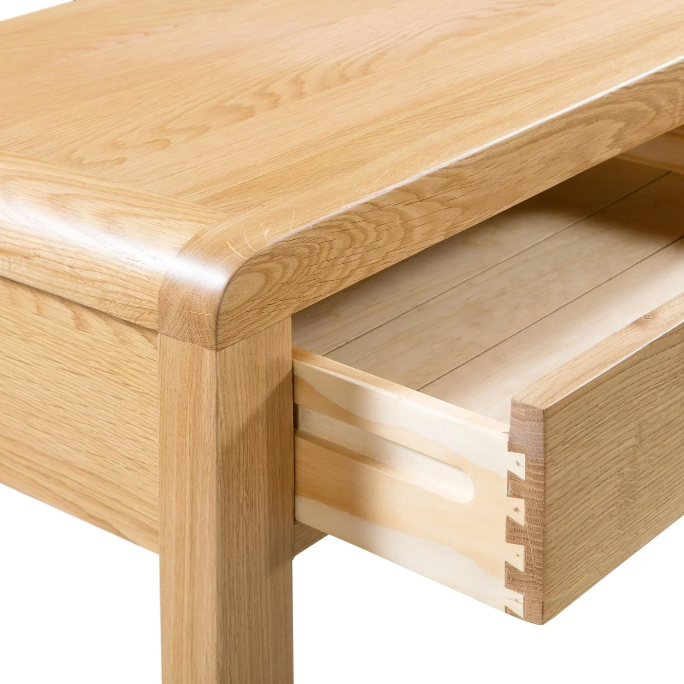 Oak dressing table with open dovetail drawer showing wood grain and corner detail