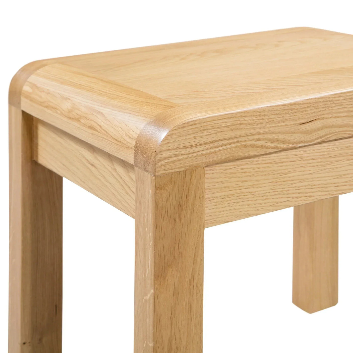Close detail of light oak dressing table stool with curved edges and visible wood grain
