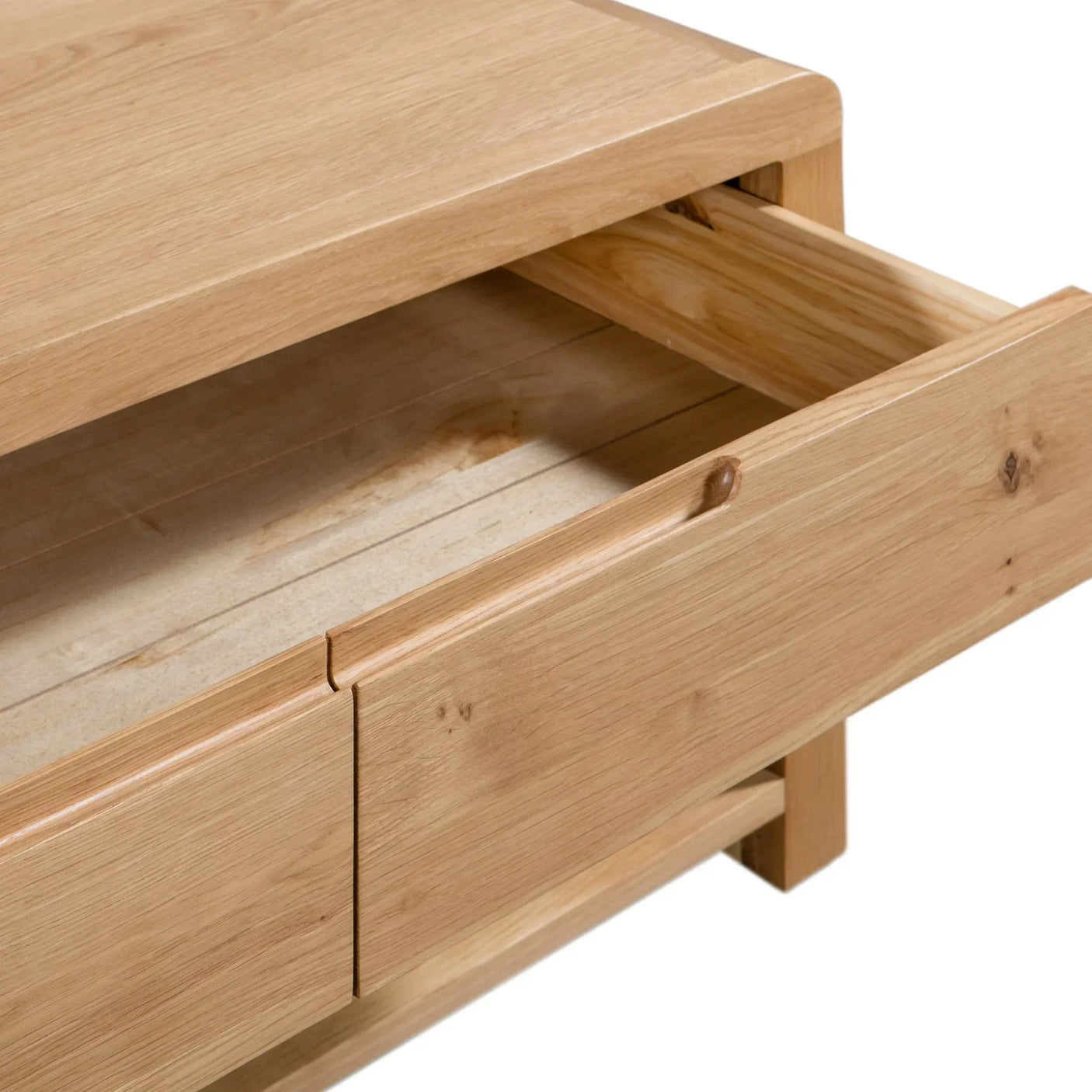 Oak coffee table close-up showing integrated drawer with smooth wood grain finish