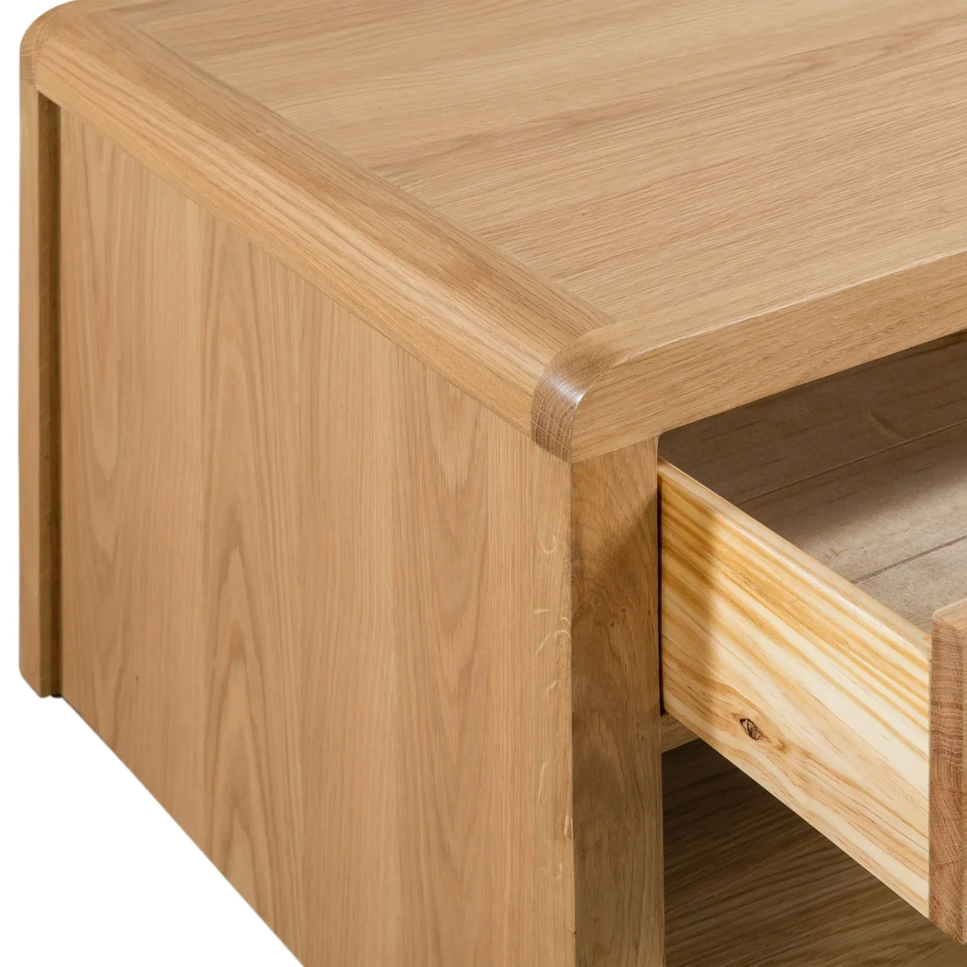 Oak coffee table corner with rounded edge and open drawer detail