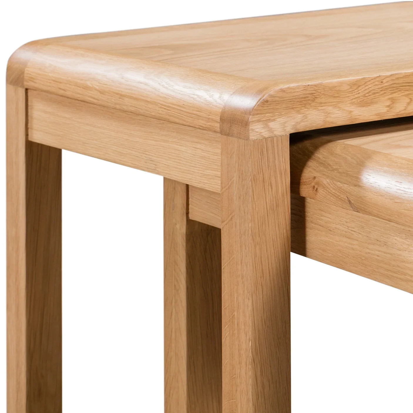 Close-up of oak nest of tables with rounded edges and visible wood grain
