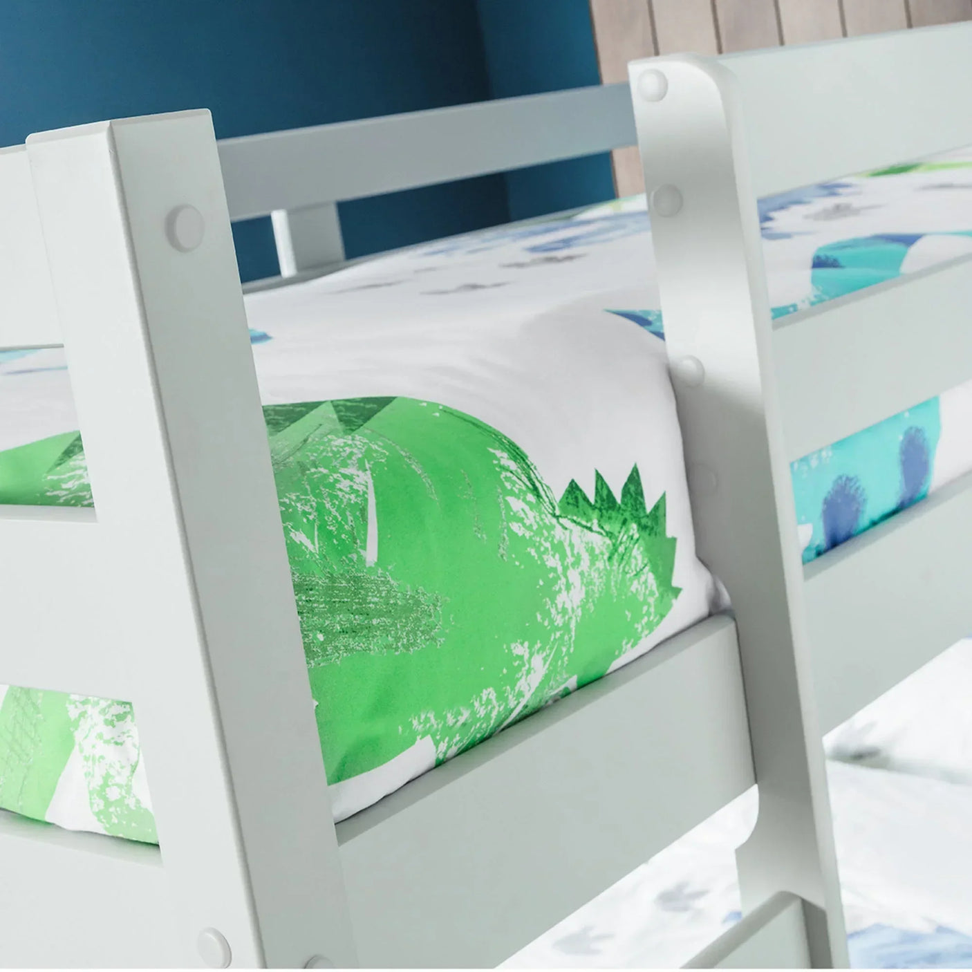 Grey wooden bunk bed ladder and side rail closeup with green and blue bedding