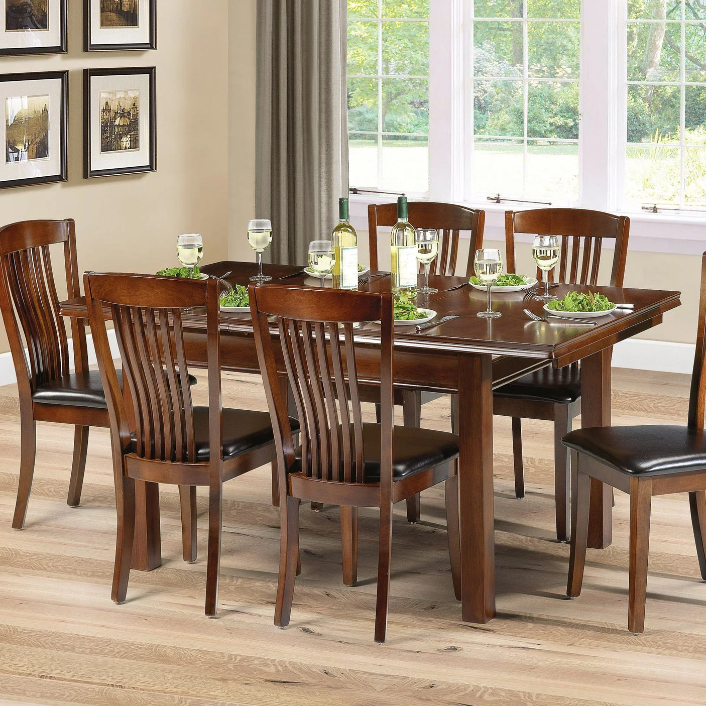 Wood dining table set with six chairs, black seat pads, set for meal in bright dining room