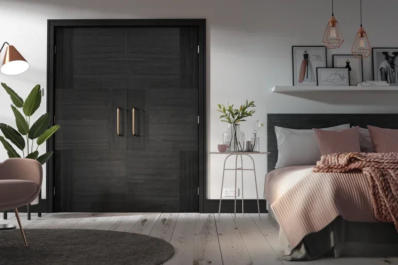 Charcoal black internal double doors with gold handles in modern bedroom setting
