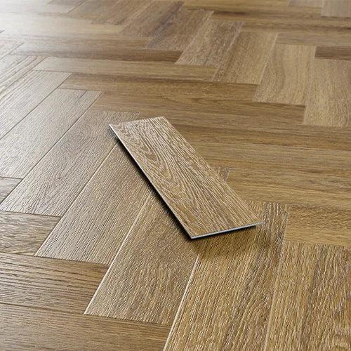 Chestnut wood effect flooring plank on herringbone patterned laminate floor