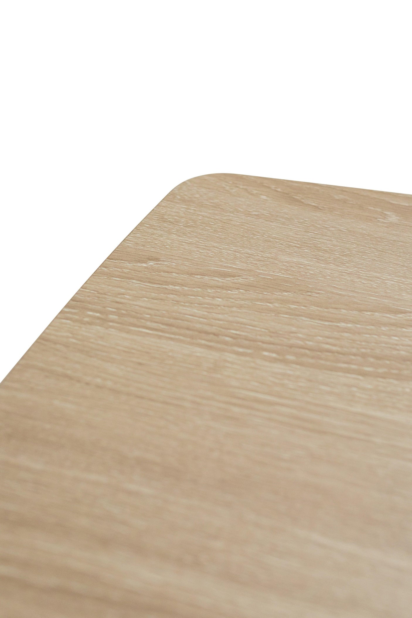 Light oak effect table corner with visible wood grain and smooth rounded edge