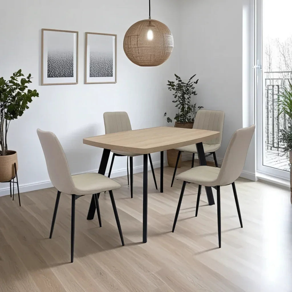 Modern dining chair with cream upholstery and black legs at light wood table in bright room