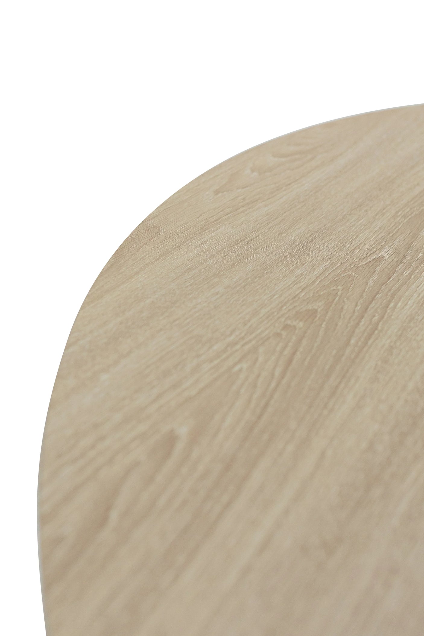 Closeup of round light oak table top with natural wood grain texture