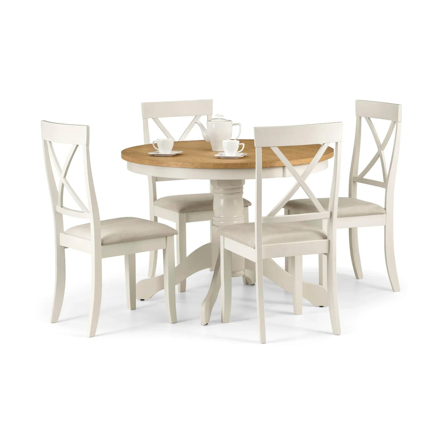 Round wood dining table with pedestal base and four cream chairs, set for tea