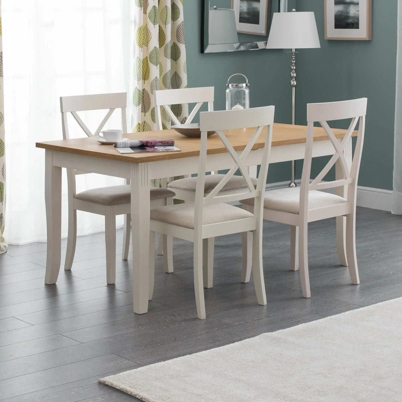 Oak extending dining table with four white chairs in modern dining room