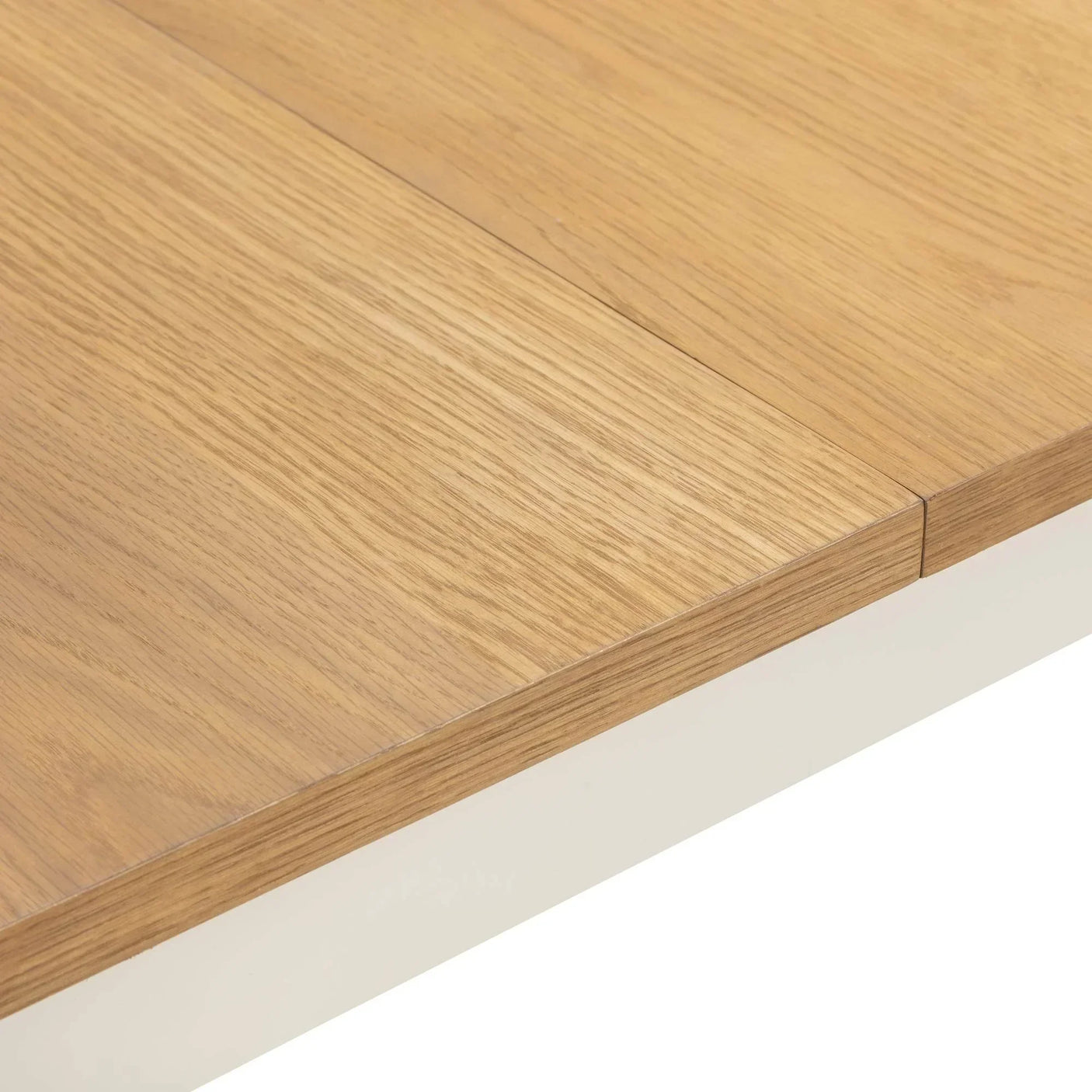 Oak wood extending dining table top with visible join detail and natural grain finish