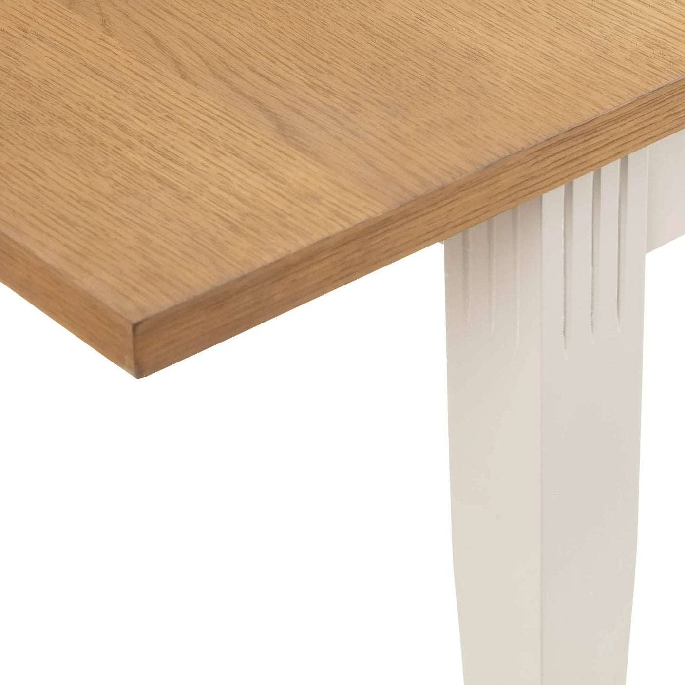 Oak extending dining table corner detail with white painted leg