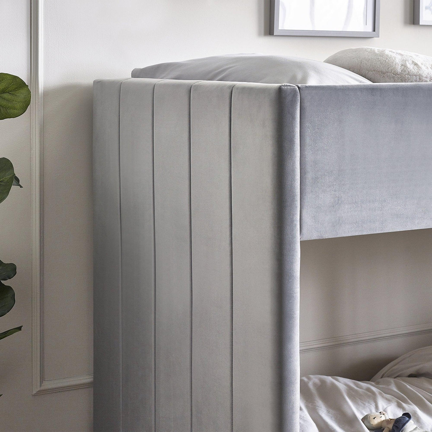 Grey fabric bunk bed with vertical panel detail in modern bedroom setting