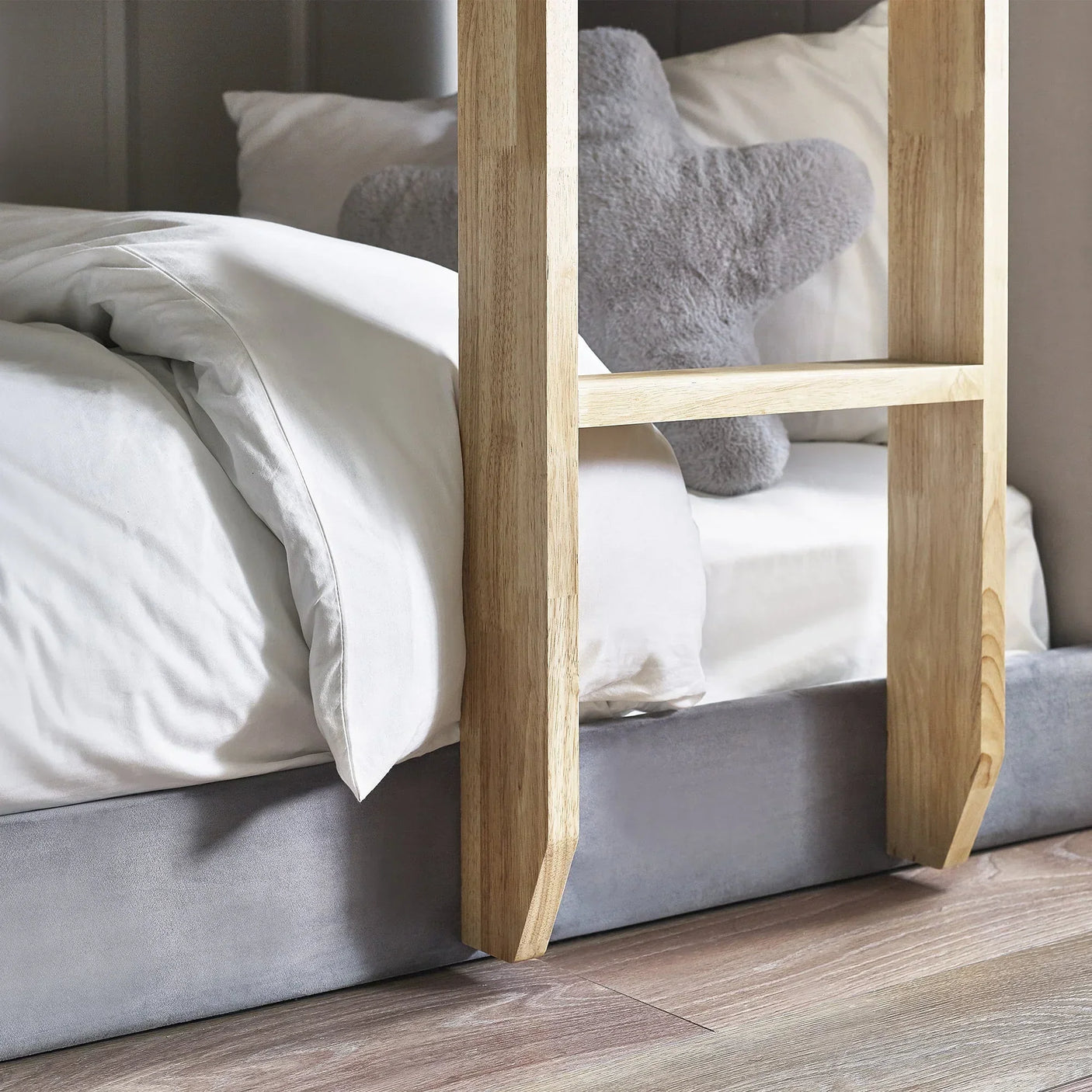 Daytona fabric bunk bed ladder detail with grey plush cushion and white bedding