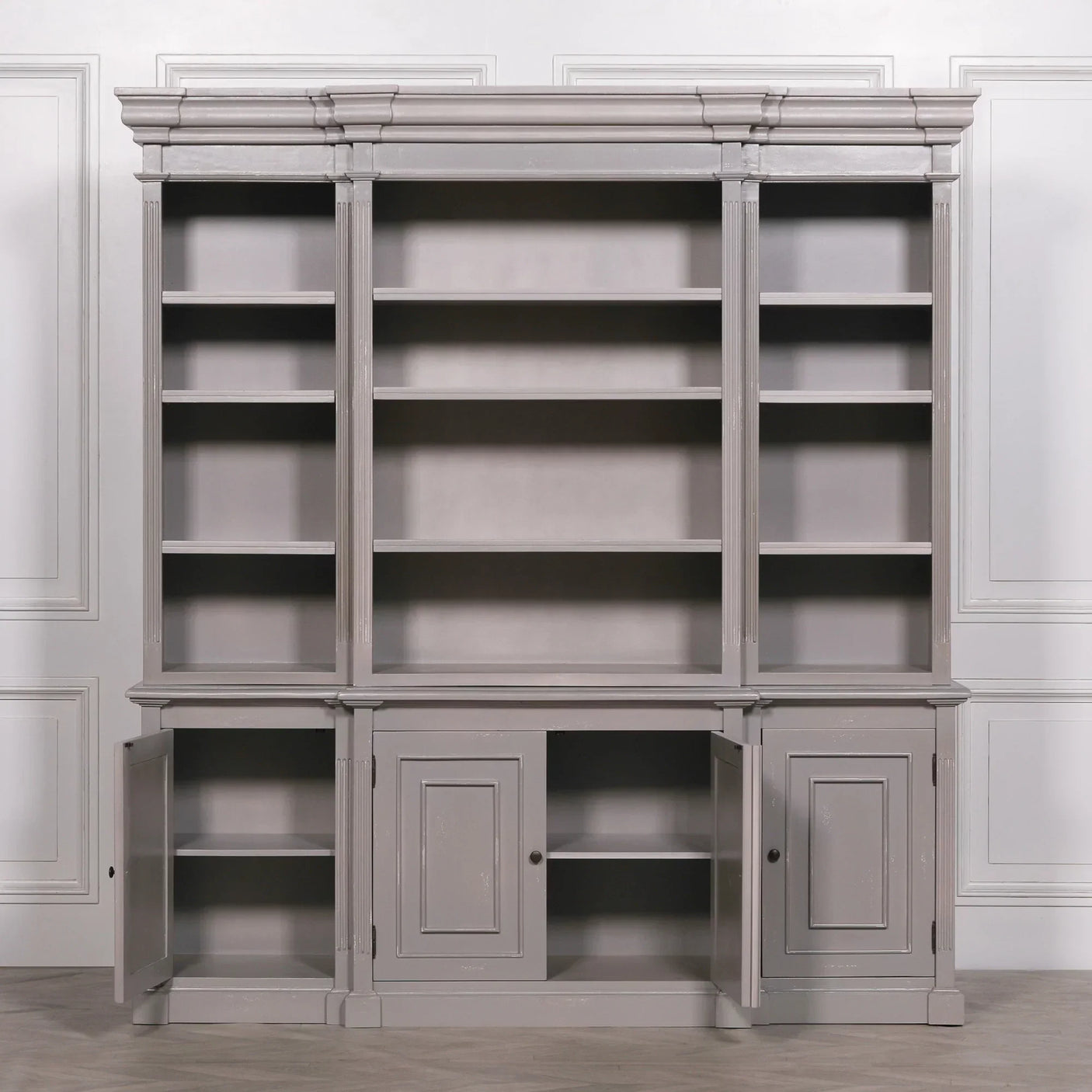 Grey wooden bookcase with open shelving and base cupboards in classic style