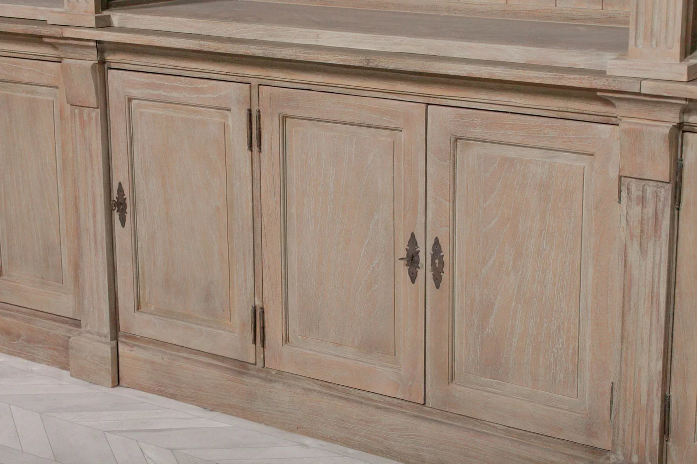 Light oak sideboard cabinet with panelled doors and decorative metal handles