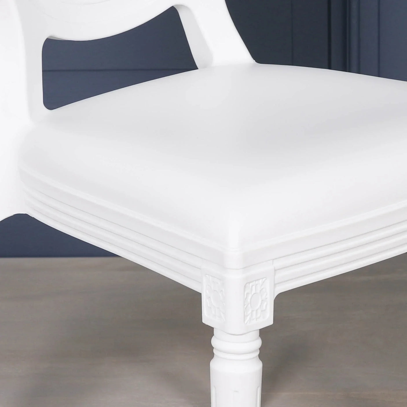 White wooden dining chair seat with carved detail on front leg
