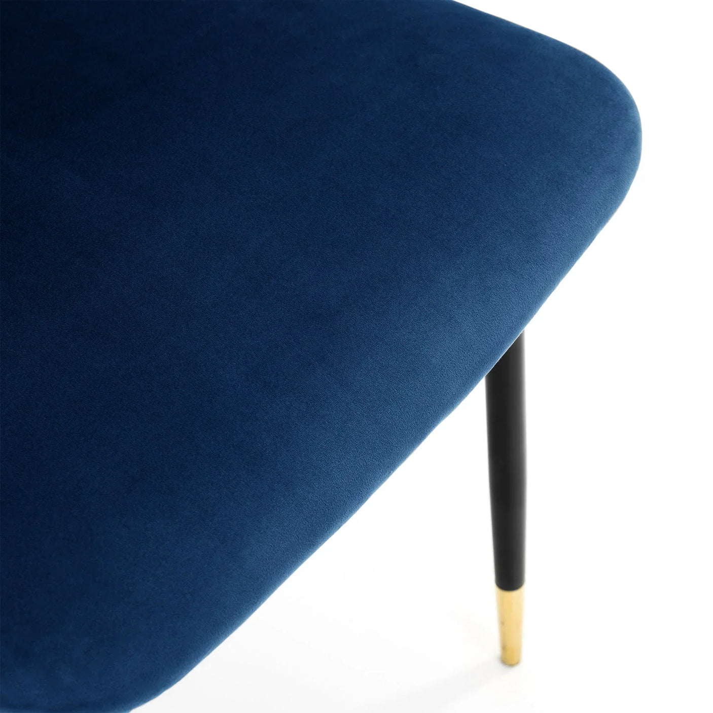 Close-up of blue dining chair seat with black leg and gold tip detail