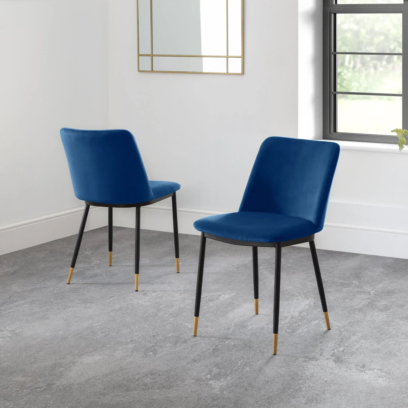 Blue dining chairs with black legs and gold tips in modern room by window and mirror